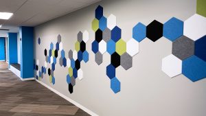 video meeting background shows multi colored wall tiles applied to office wall